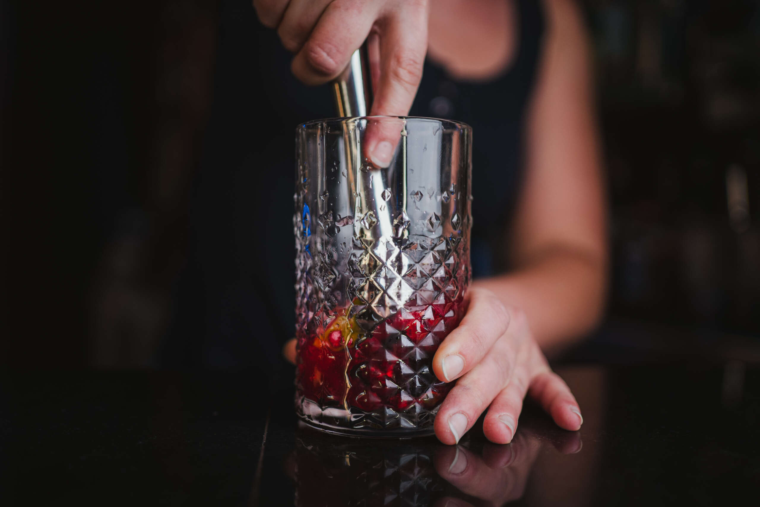 Woman preparing fruit mojito at a bar